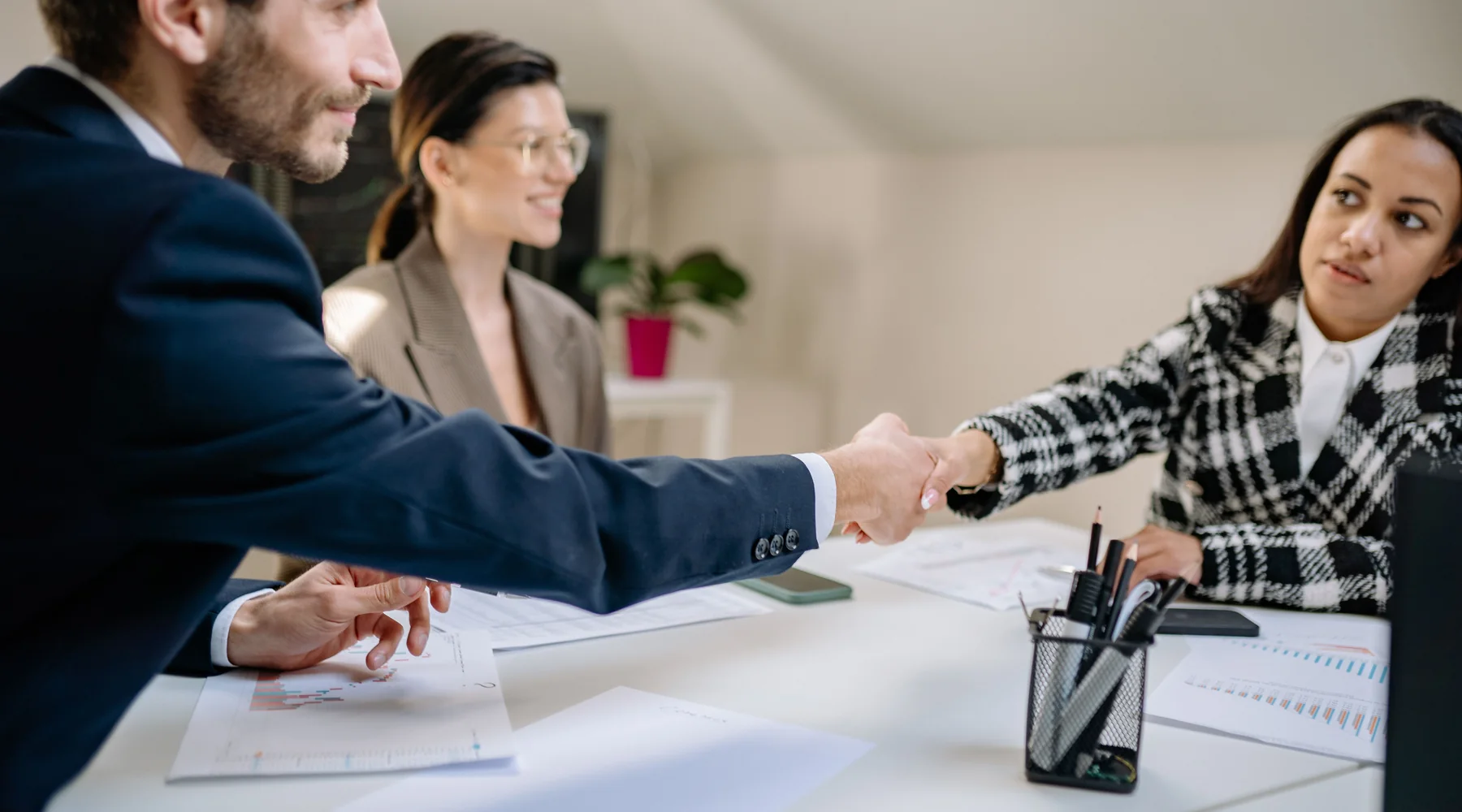 Business professionals shaking hands after a constructive planning meeting
