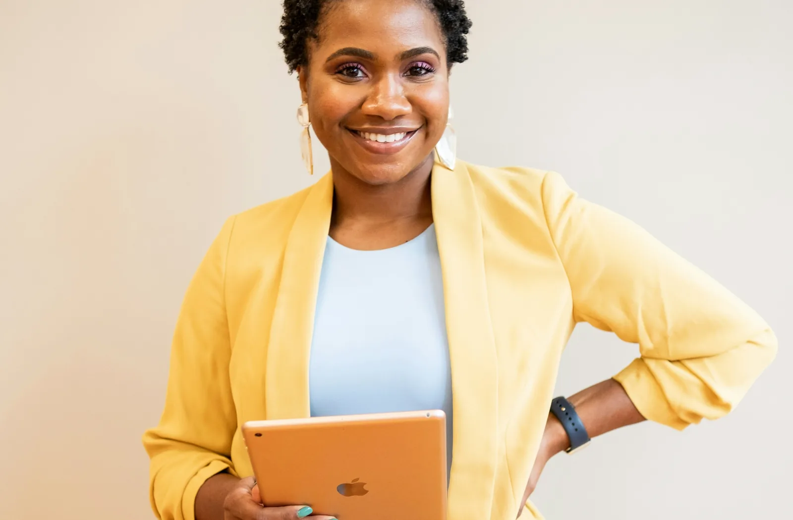 A digital business leader holding a tablet and preparing to support customers
