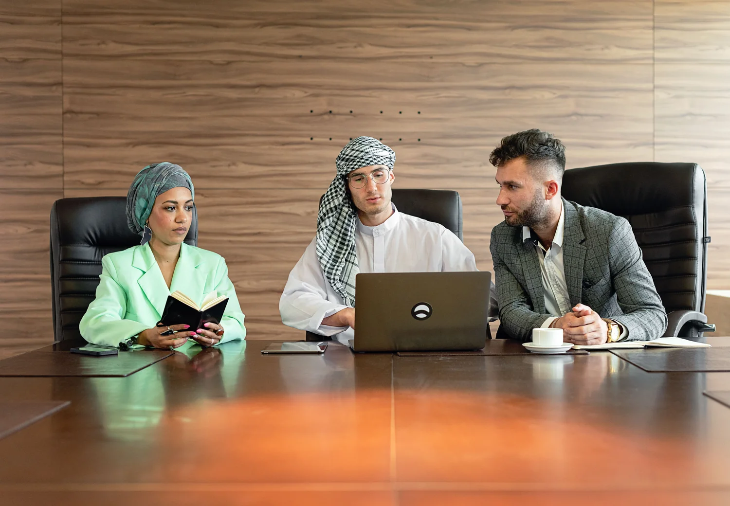 International business professionals reviewing a plan together around a conference table