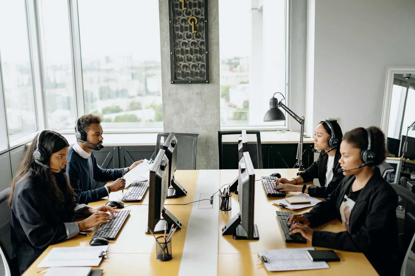 Operations professionals monitoring telecom transaction status and reporting