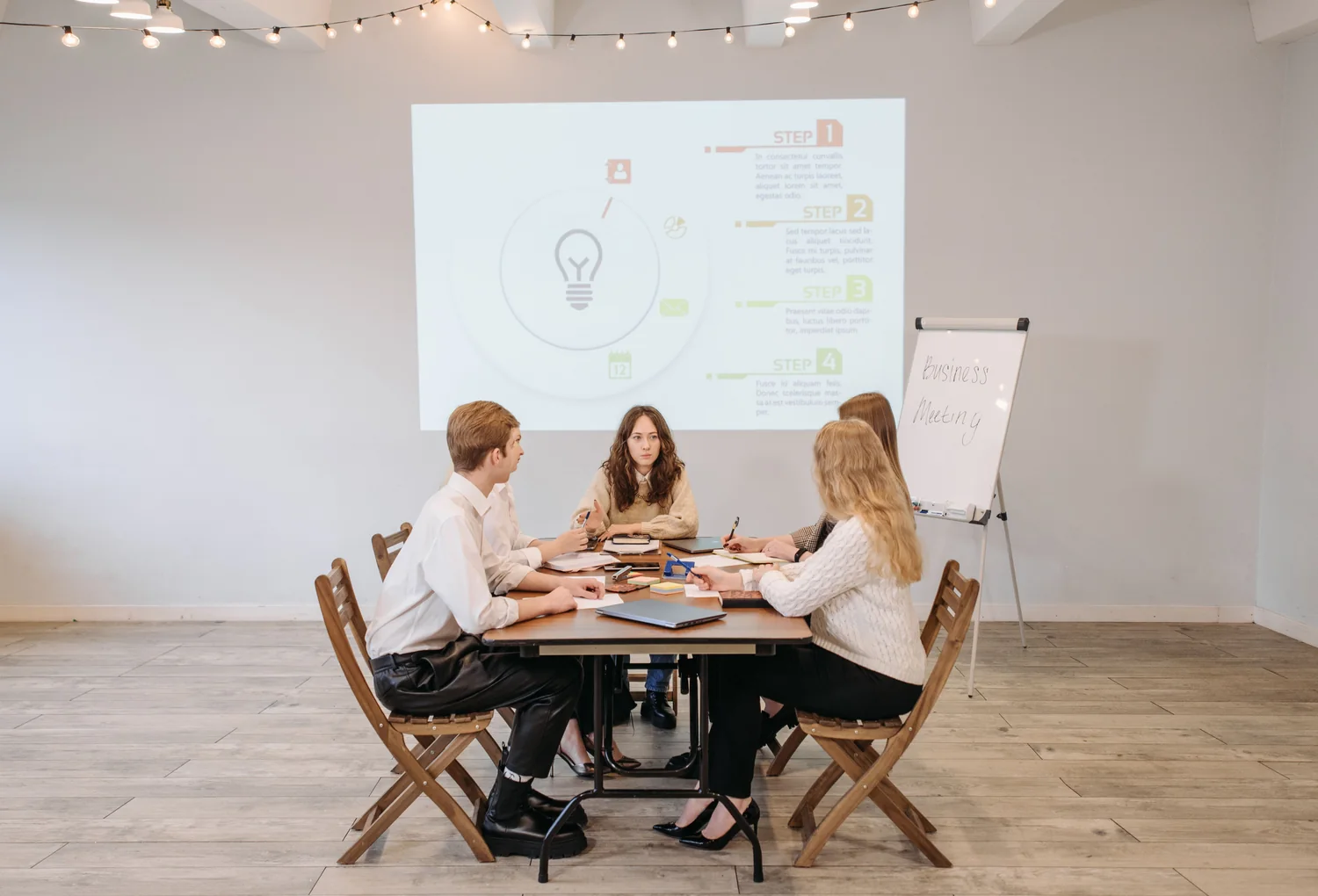 A business team discussing a strategy presentation in a collaborative workshop