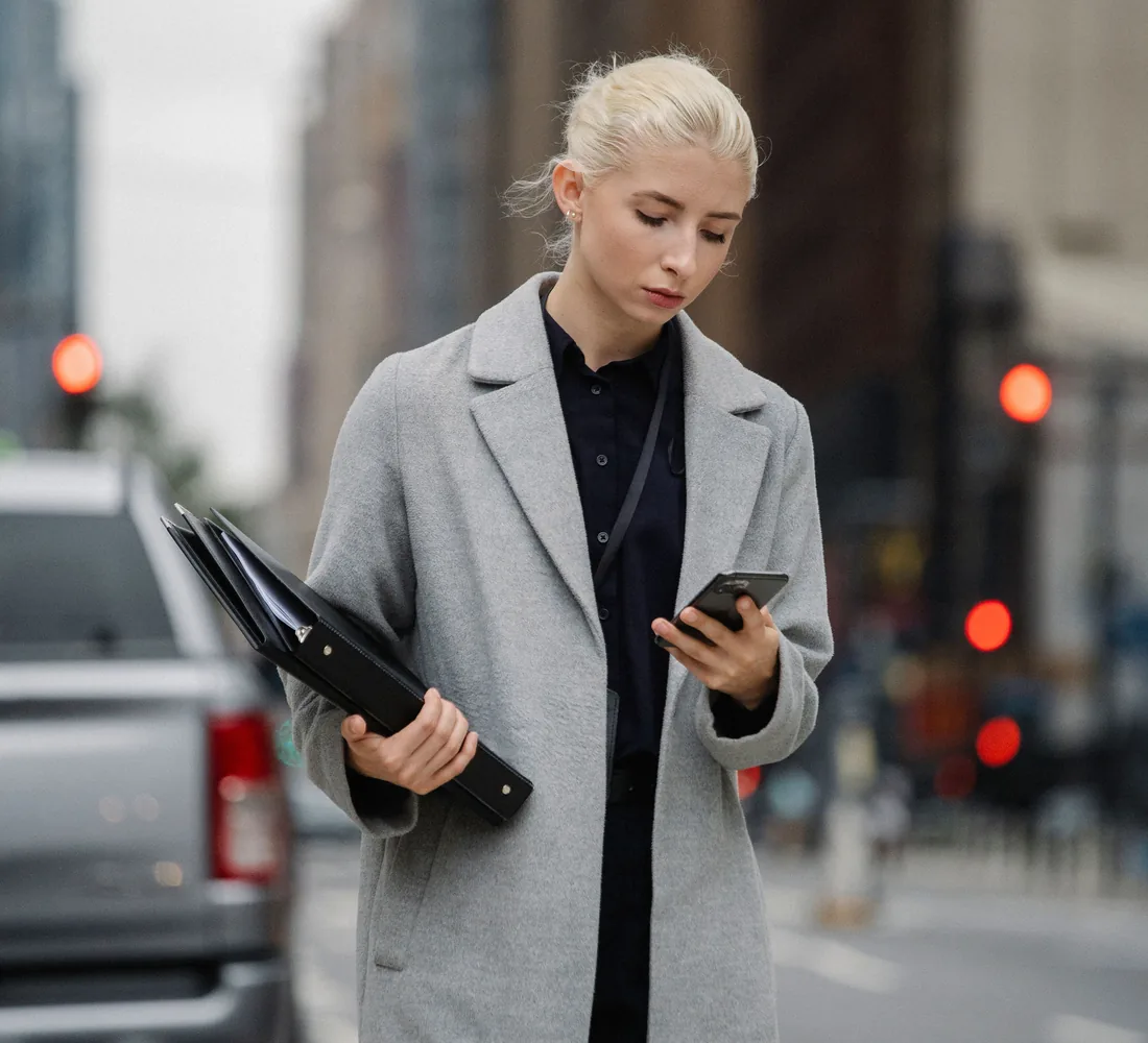 A professional using a mobile service while travelling through a city